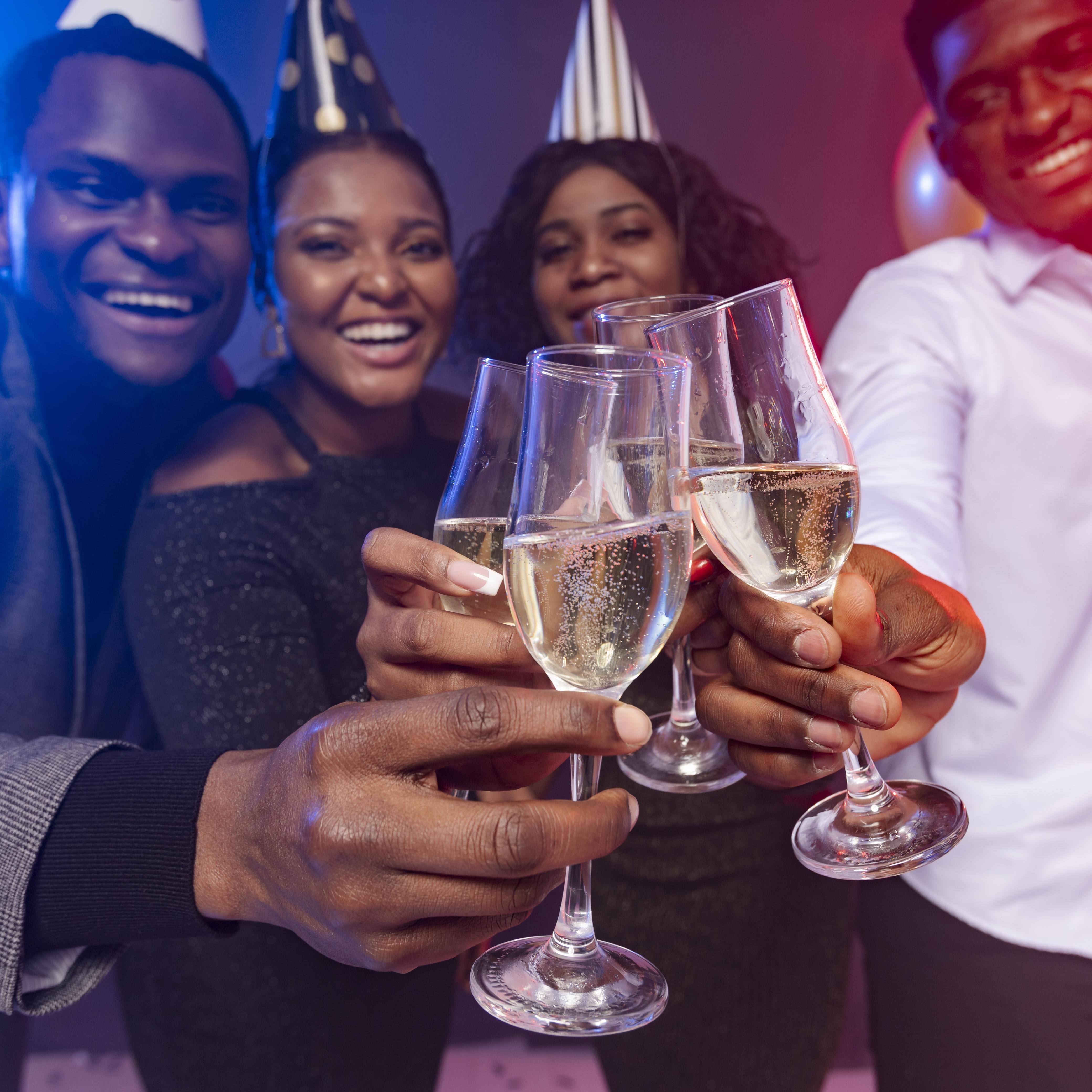 friends-wearing-party-hats-toasting-with-champagne